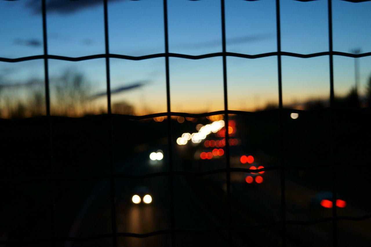 CLOSE-UP OF ILLUMINATED CITY AGAINST SKY