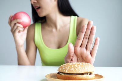 Midsection of woman eating apple