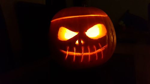 Close-up of illuminated pumpkin against black background