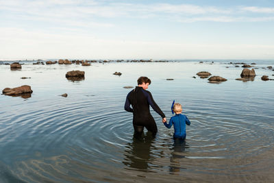 Father and young son preparing to snorkel