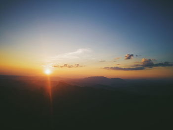 Scenic view of silhouette mountains against sky during sunset