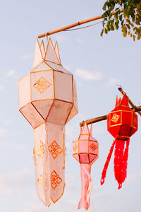Low angle view of paper lanterns hanging against sky