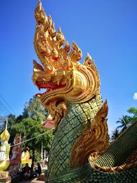 Low angle view of statue against sky