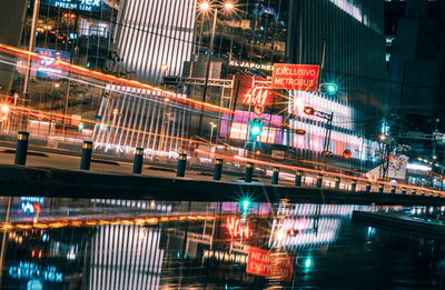 Light trails on bridge in city at night