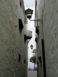 Narrow alley amidst buildings against sky