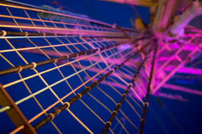 Close-up of illuminated metal fence at night