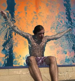 Teenage boy swimming at pool