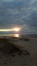 Scenic view of beach at sunset