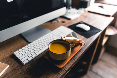 High angle view of coffee and laptop on table