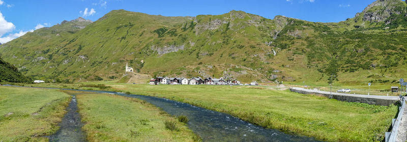 Small village in the mountains with stone houses, flowers and a river in val formazza