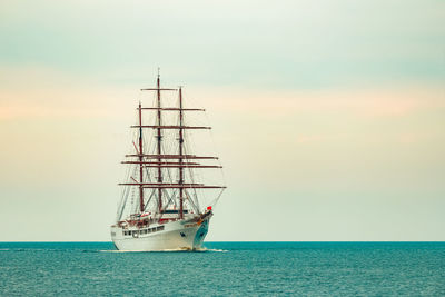 Sailboat sailing in sea against sky