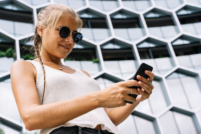 Midsection of woman using mobile phone