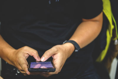 Close-up of man using mobile phone