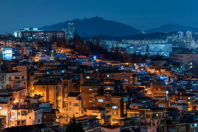 High angle view of illuminated cityscape against sky at night