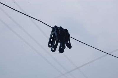 Close-up low angle view of cables against the sky