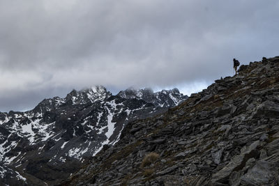 Figure on a rocky ridge, in the snowy mountains of new zealand