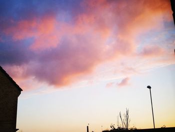 Low angle view of silhouette street light against sky during sunset