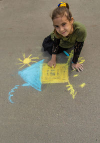 High angle view of boy playing on sand