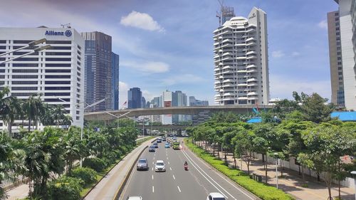 View of city street and buildings against sky