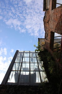 Low angle view of abandoned house against sky