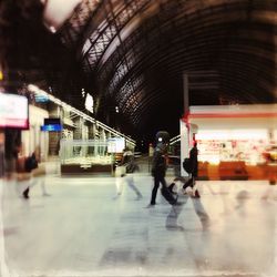 Blurred motion of woman walking on sidewalk