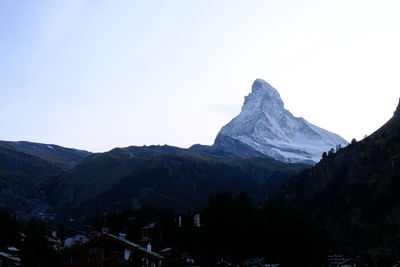 Scenic view of snowcapped mountains against clear sky