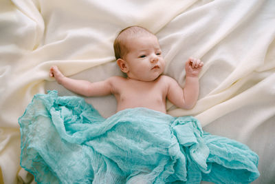 High angle view of baby boy sleeping on bed at home