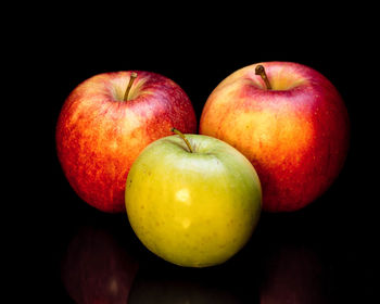 Close-up of apples on apple against black background