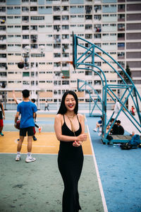 Full length portrait of woman standing in city