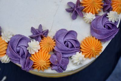 High angle view of purple flowers on a cake 