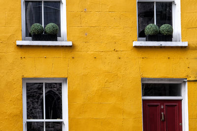 Low angle view of yellow window