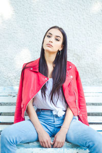 Portrait of beautiful young woman sitting outdoors