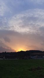 Scenic view of field against sky during sunset