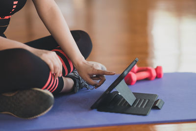 Low section of woman exercising in gym