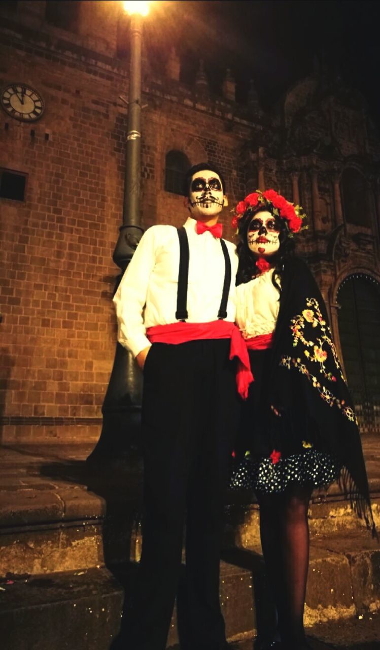 two people, costume, lifestyles, leisure activity, real people, men, night, spooky, built structure, togetherness, couple - relationship, standing, young women, building exterior, full length, women, architecture, young adult, outdoors, halloween, clown, people