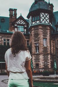 Rear view of woman looking at building