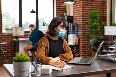 Young woman using laptop on table