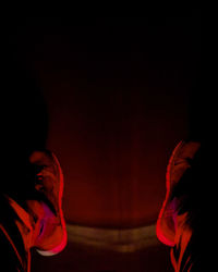 Close-up portrait of man against black background