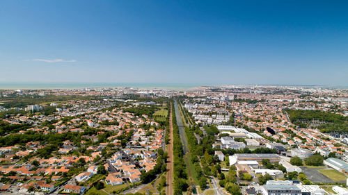 High angle view of townscape against clear blue sky