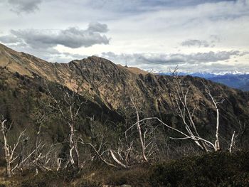 Scenic view of mountains against cloudy sky