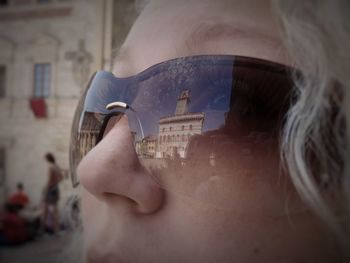 Cropped image of woman with comune di montepulciano reflection on sunglasses