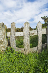 Wooden structure on field against sky