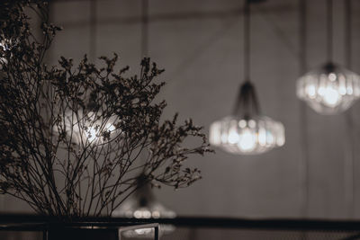 Low angle view of illuminated pendant light hanging from ceiling