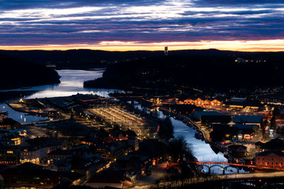 High angle view of illuminated city buildings at sunset