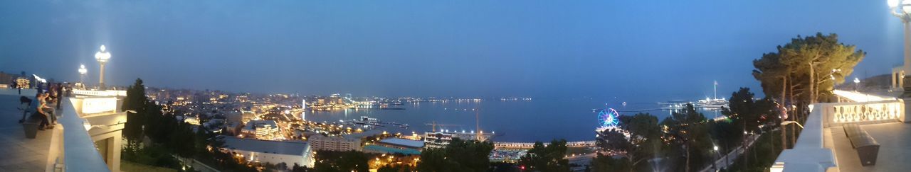 water, panoramic, building exterior, built structure, sea, nautical vessel, architecture, harbor, clear sky, illuminated, moored, transportation, sky, city, mode of transport, copy space, palm tree, boat, outdoors, waterfront