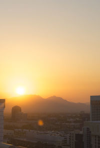 Cityscape against clear sky during sunset