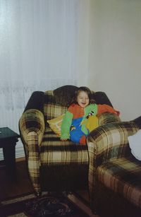 Woman sitting on sofa at home