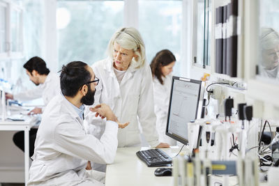 Coworkers talking in laboratory