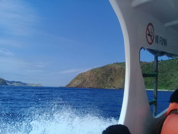 Close-up of boat in sea against sky