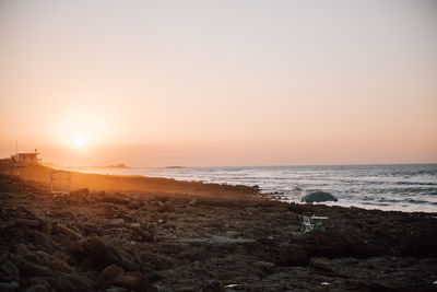 Scenic view of sea against clear sky during sunset